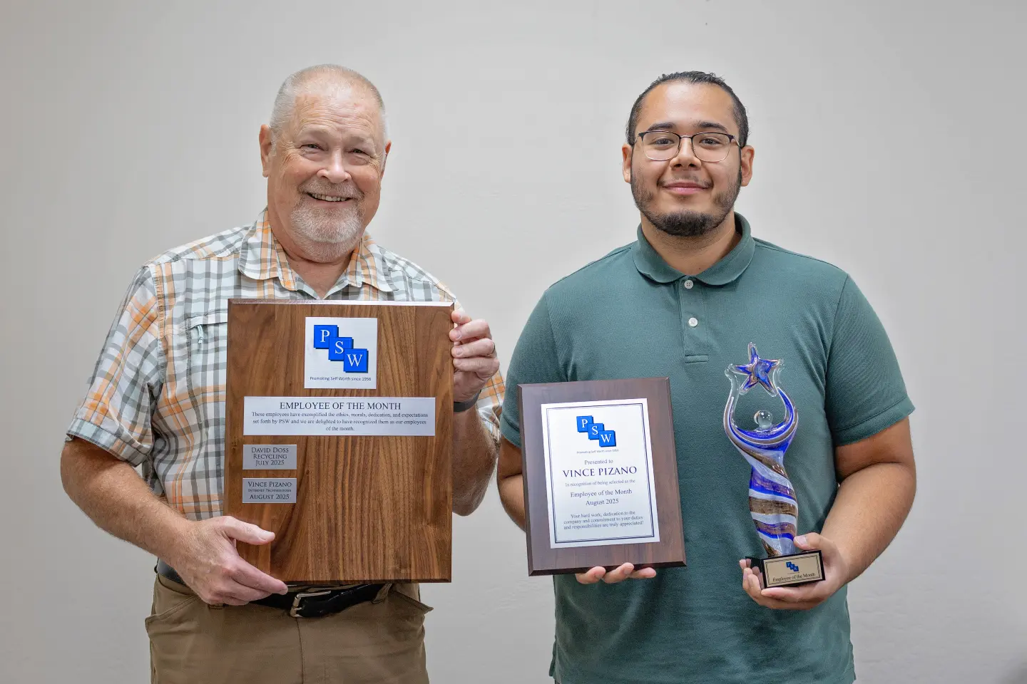 Photo of Vince, Employee of the Month for August, holding his Employee of the Month plaque with his supervisor, Del.